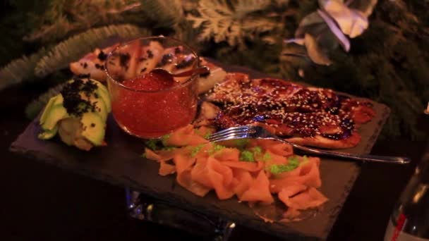 Serving with seafood and caviar decoration at candlelight — Video