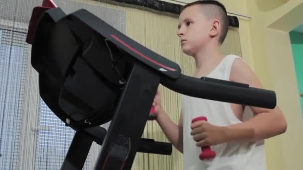 Boy Running Treadmill Dumbbells His Hands — Stockvideo