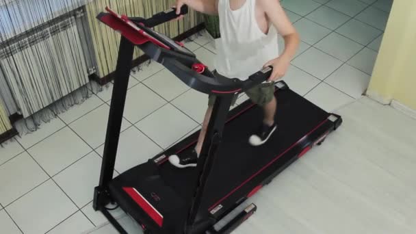 Guy Goes Sports Home Treadmill Top View His Feet — Stock Video