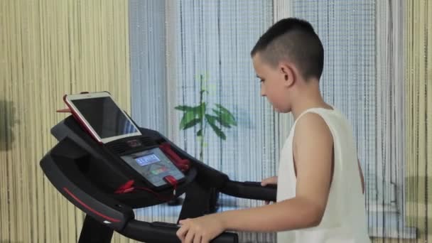 Boy Running Treadmill Dumbbells His Hands — Stock Video