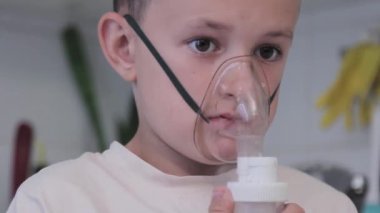 Child breathes an inhaler, being treated for colds and viruses
