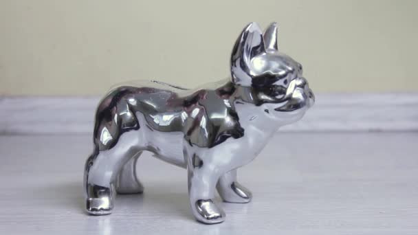 Hand Lowers Coins Silver Shiny Piggy Bank Shape Dog — стоковое видео