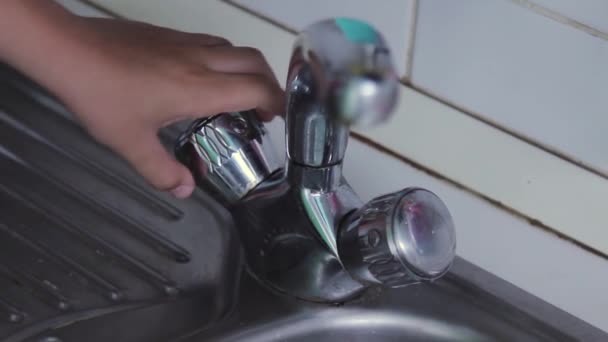 Boy Hand Turns Water Tap Kitchen Closeup Plane — Stockvideo