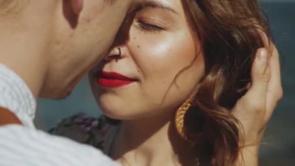 Woman with closed eyes hugs her boyfriend. Portrait of happy loving couple hugs. woman with red lips. — Stockvideo