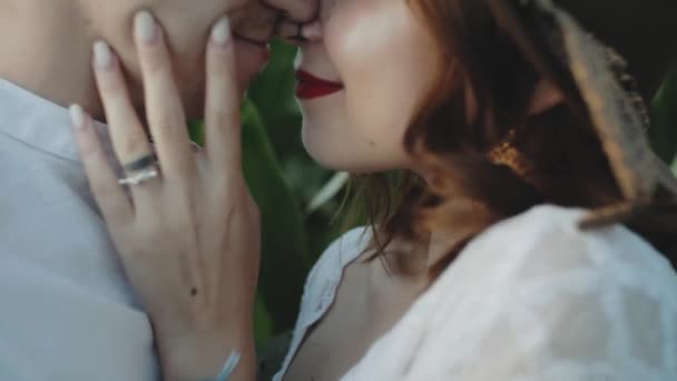 Loving couple in the corn field. slow motion.Close-up couple hugging and kissing farmland.Caucasian woman holding guys face in her arms with closed eyes.Date, love and lifestyle concept. — Wideo stockowe