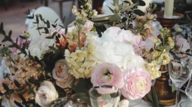 Beautiful wedding decor, all decorated in pastel pink and white colors, camera moving slow motion. Medium shot festive bouquet on the table. High quality FullHD footage