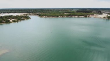 Aerial view of beautiful landscape, blue lake and pine forest. Nature of Ukraine, Aerial over beautiful lake with clear water. High quality 4k footage
