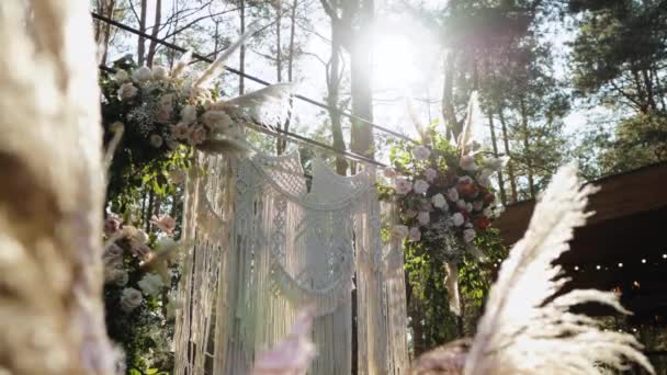 屋外の結婚式の終わりに美しいボヘミアンアーチの装飾 パステルカラーの花序構成 夏の田舎の結婚式 高品質のフルHd映像 — ストック動画