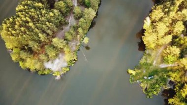 Aerial view of small island with pine trees in the middle of the lake. Close-up shot of island. High quality 4k footage