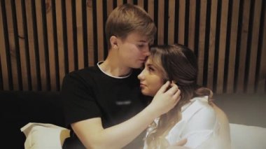 Couple in love hugs, medium shot the couple hugging with their eyes closed, slow motion, guy touches female hair. High quality 4k footage