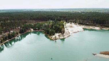 Aerial view of beautiful landscape, blue lake and pine forest. Nature of Ukraine, Aerial over beautiful lake with clear water. High quality 4k footage