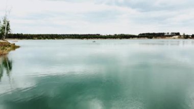 Aerial view of beautiful landscape, blue lake and pine forest. Nature of Ukraine, Aerial over beautiful lake with clear water. High quality 4k footage