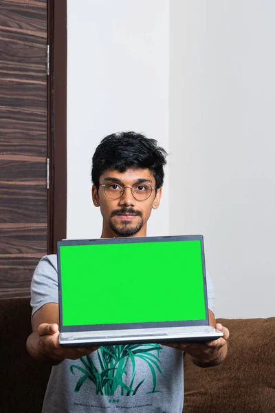 Young Indian Boy Holding Laptop Green Screen His Hands While — Stock Photo, Image