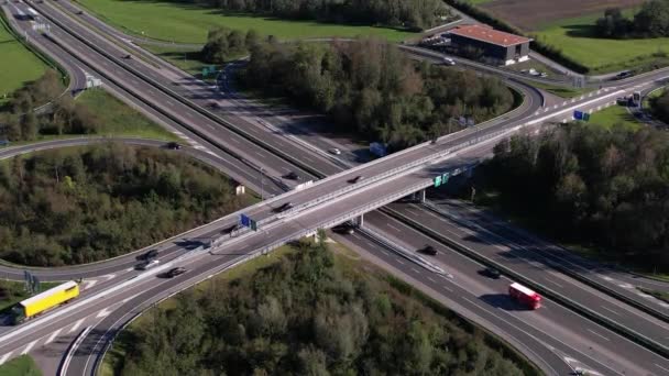 Heavy traffic on swiss highway intersection with motorway bridge, aerial orbit — Stock Video