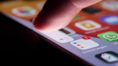 BILTEN - JANUARY 4, 2022, User lowering volume with finger on smartphone