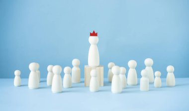 Successful leader concept.Wood doll model on blue background