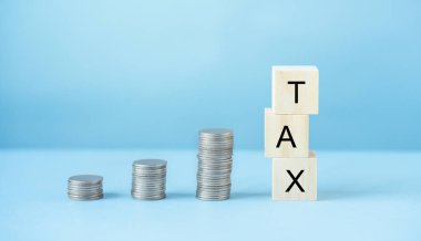 Stacked of Coins with Wood block and word, Income Tax Raise Concept.