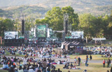 Blurred image people enjoying watching concert an outdoors music, community event, festival.