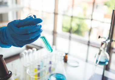 Test tubes with liquid in laboratory,Scientist working at the laboratory.