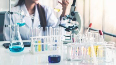 Test tubes with liquid in laboratory,Scientist working at the laboratory.