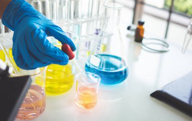 Test tubes with liquid in laboratory,Scientist working at the laboratory.