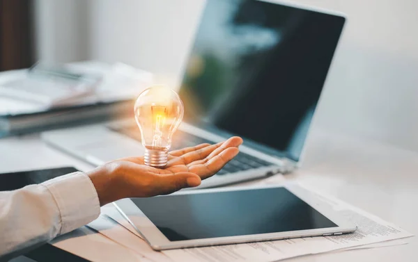 Hand Holding Light Bulb Laptop Wooden Desk Creative New Idea Foto Stock Royalty Free