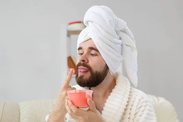 Man enjoying when smell scrub for skin while holds in hand. Spa, body and skin care for man concept