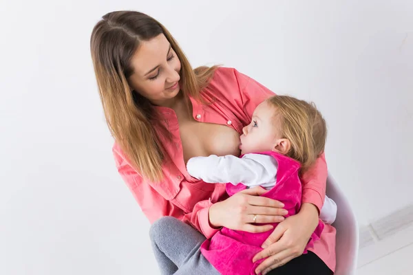 Moederschap en gezin concept - moeder borstvoeding en knuffelen haar baby. — Stockfoto