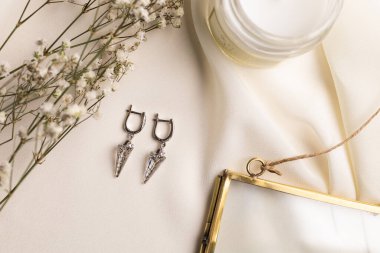 Handmade jewelry on a textile background. Gift for women. Bijouterie and jewellery for women