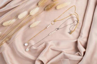 Handmade jewelry on a textile background. Gift for women. Bijouterie and jewellery for women