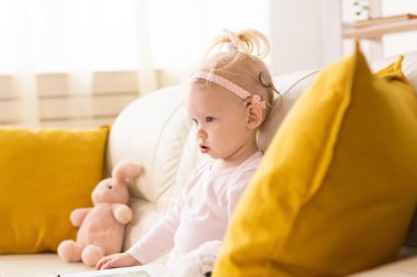 Cochlear implant for baby. Deaf child with hearing aid. Health care and medicine technology and innovations