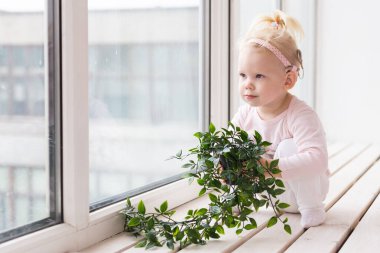 Cochlear implant for baby. Deaf child with hearing aid at home. Copy space an place for advertising