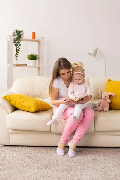 Child girl with cochlear implant with her mother at home. Hear impairment and deaf community concept