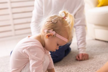 Cochlear implant for baby. Deaf child with hearing aid. Health care and medicine technology and innovations