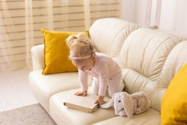 Cochlear implant for baby. Deaf child with hearing aid at home - diversity concept