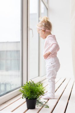 Cochlear implant for baby. Deaf child with hearing aid. Health care and medicine technology and innovations and diversity concept