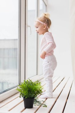 Cochlear implant for baby. Deaf child with hearing aid at home - diversity concept