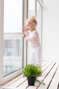 Baby with cochlear implants at home. Deafness and medical technology and diversity concept.