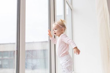 Cochlear implant for baby. Deaf child with hearing aid at home - copy space and place for advertising