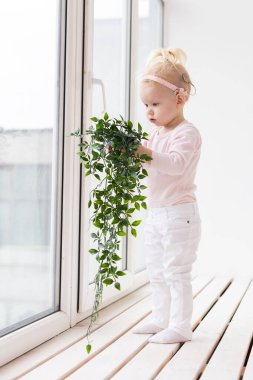 Baby with cochlear implants at home. Deafness and medical technology and diversity concept.