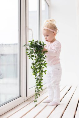 Cochlear implant for baby. Deaf child with hearing aid. Health care and medicine technology and innovations and diversity