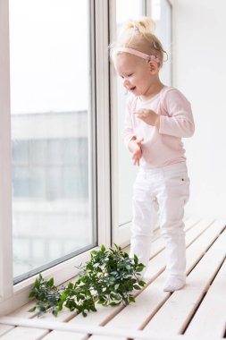 Baby with cochlear implants at home. Deafness and medical technology and diversity concept.