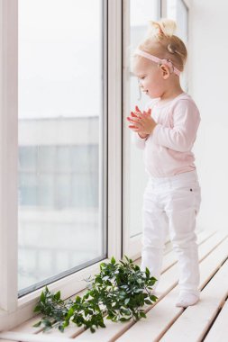 Cochlear implant for baby. Deaf child with hearing aid at home - diversity