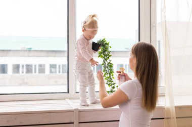 Baby with cochlear implants at home. Deafness and medical technology concept.