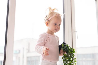 Cochlear implant for baby. Deaf child with hearing aid at home