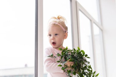 Cochlear implant for baby. Deaf child with hearing aid at home