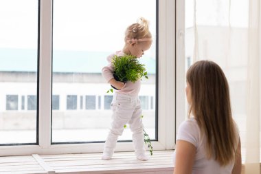 Baby with cochlear implants at home. Deafness and medical technology concept.