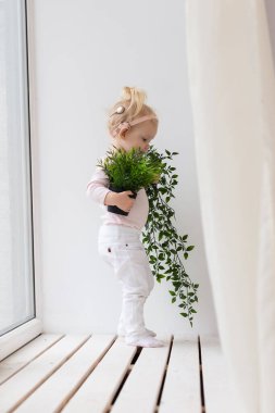 Baby with cochlear implants at home. Deafness and medical technology concept.