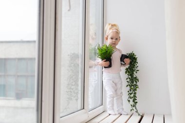 Baby with cochlear implants at home. Deafness and medical technology concept.