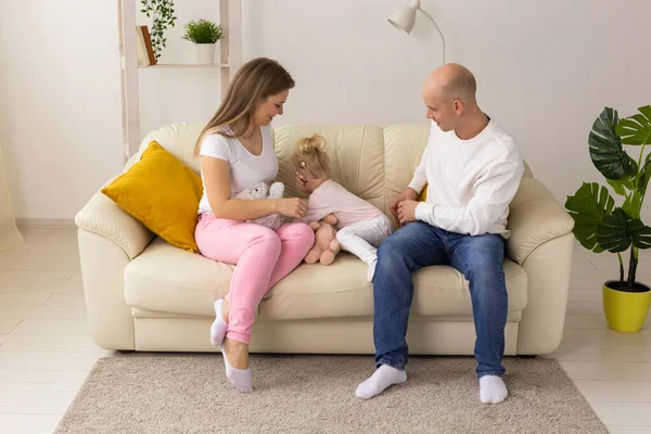 Happy child girl with cochlear implant having fun with her family - hearing aid for deaf and innovative health technology concept